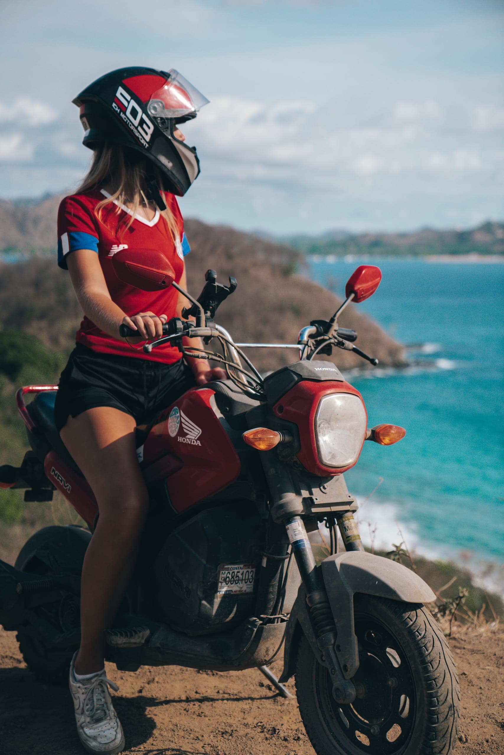 A rider on a Honda Navi above the bay near Tamarindo