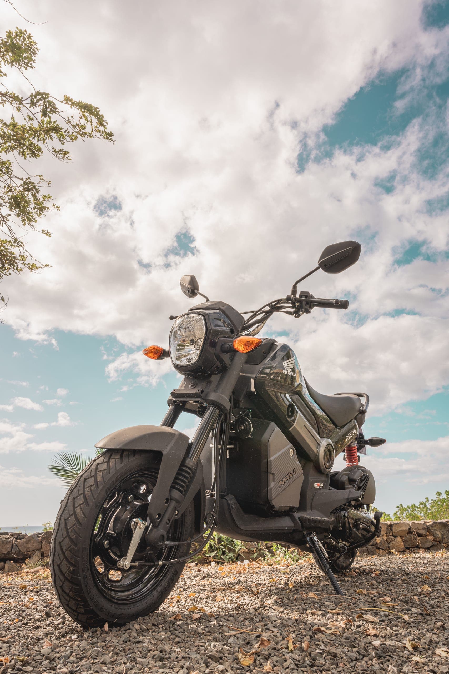 A Honda Navi under a big blue sky by the sea