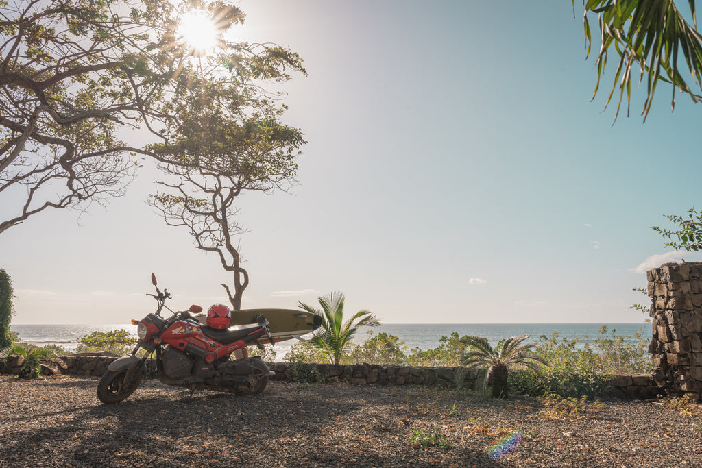 Honda Navi scooter with surf rack near the beach in Tamarindo