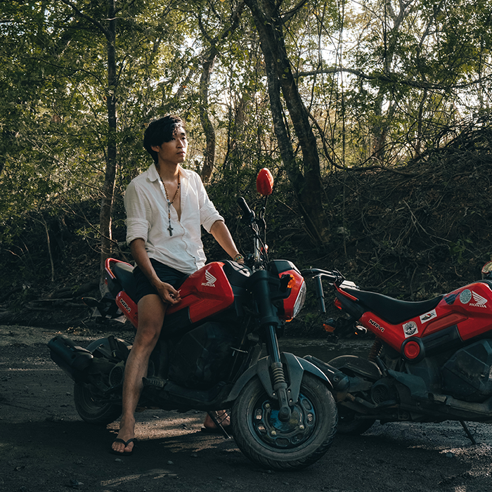 Ohana Rental Tamarindo Founder Adam riding on a Honda Navi Scooter on a dirt road at the Tamarindo Estuary