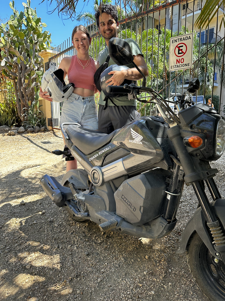 Ohana Rental Client Testimonial - Rujul Kumar standing next to a Honda Navi Scooter at a beach in Tamarindo